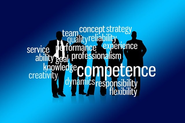 Silhouettes of a business team in the background, covered with words representing a competent team.